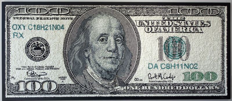 A 100 dollar bill is shown made from 80,000 painkillers glued together. 