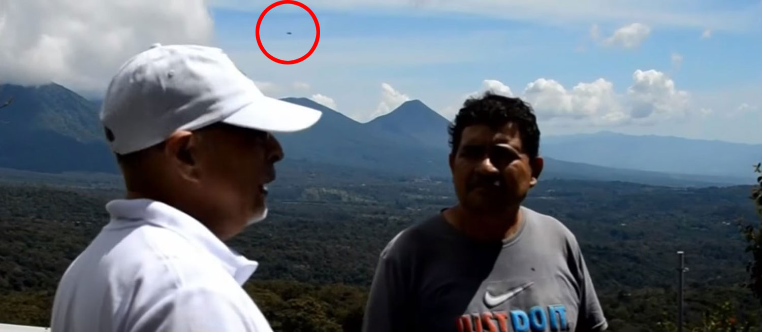 The UFO (circled) showing up in the background during an interview about UFOs with expert.