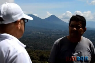 The UFO (circled) showing up in the background during an interview about UFOs with expert.