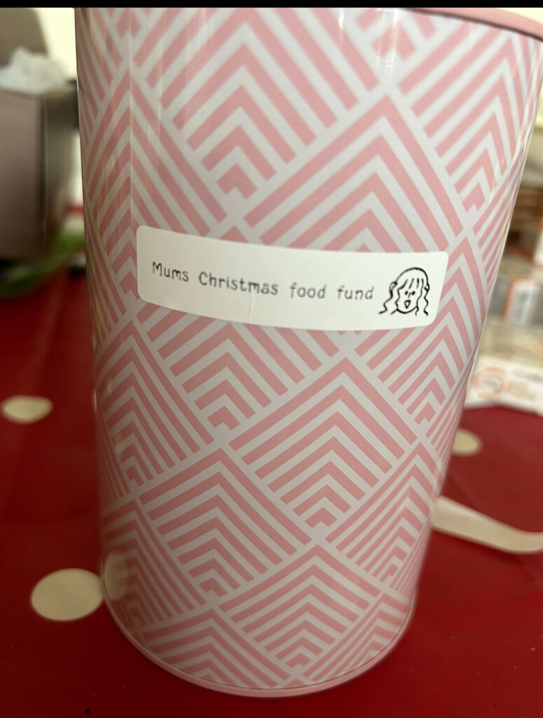 Charlotte's Christmas food fund tin.