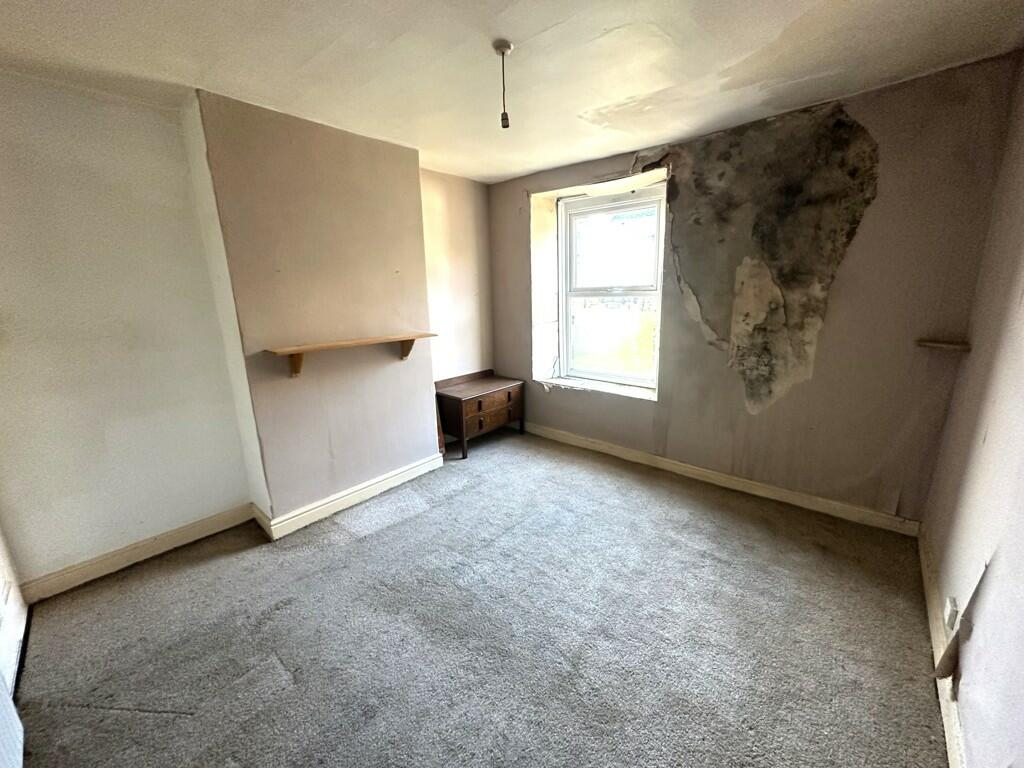 The property for sale in Sheffield with an oddly located washing machine. This shows a bedroom.