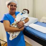 Meirivone and her newborn rag doll baby Marcelinho.