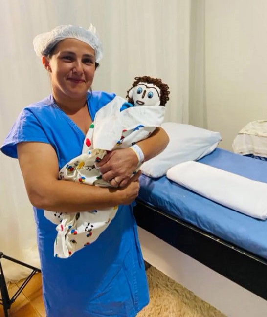Meirivone and her newborn rag doll baby Marcelinho.