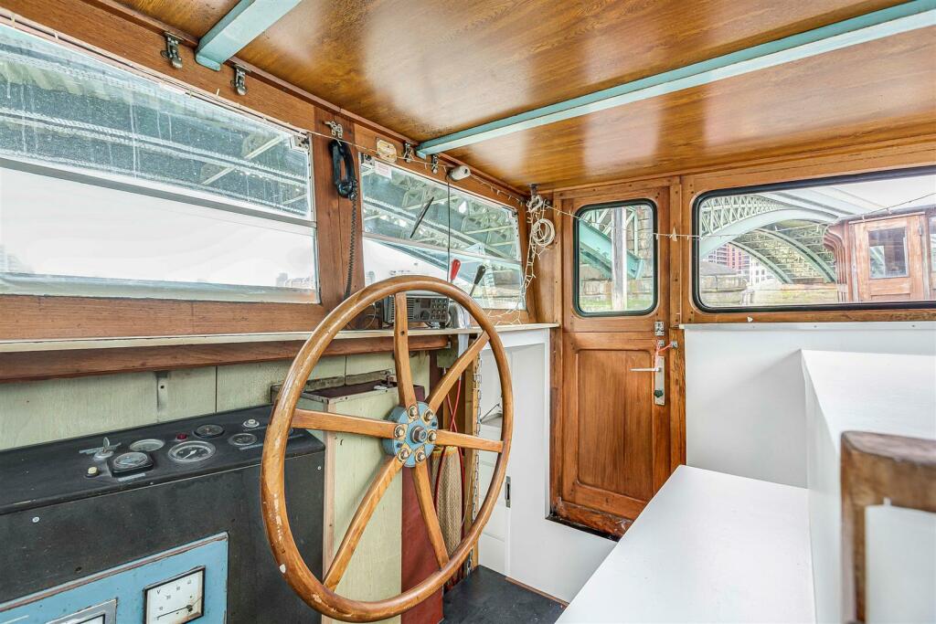 inside the one-bedroom boat house, which is available for renting in south London – on the River Thames.
