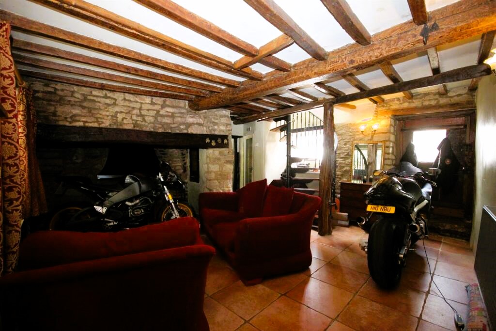 The motorbikes being parked inside of the cottage which is on the market for £275,000, in the village of Wollaston, east of Northampton.