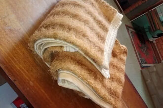 The stolen blanket which the man returned to the hotel after 30 years in brazil.