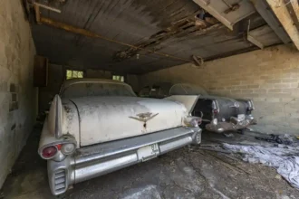Inside the abandoned property discovered by Urban explorer with vintage cars parked in the garage and driveway.
