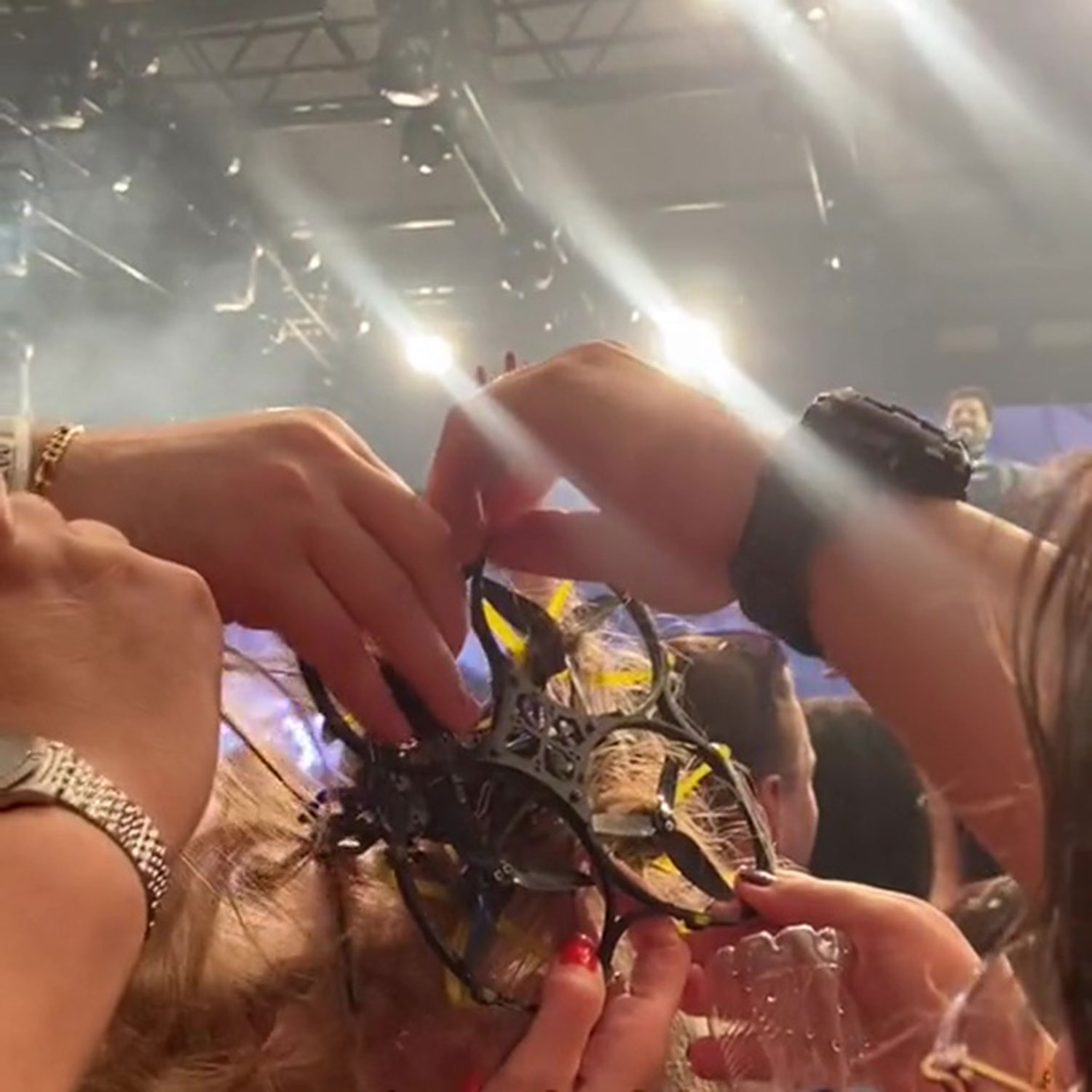 Video grab, A woman has a drone tangled in her hair during Alok's DJ concert.