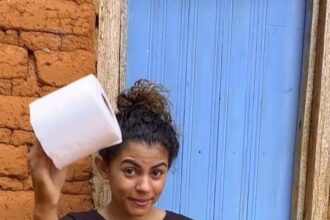 A video grab of Alessandra Araújo, recreating a white Dolce & Gabbana gown worn by model and actress, Rafa Kalimann, using loo roll.