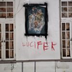 ‘Lucifer’ painted on the wall, in what is seen as blood inside the abandoned asylum discovered by urban explorer in Ontario, Canada.