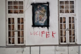 ‘Lucifer’ painted on the wall, in what is seen as blood inside the abandoned asylum discovered by urban explorer in Ontario, Canada.