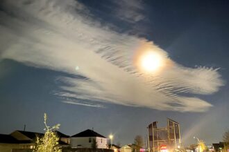A woman in Houston, Texas, spots a dragon-shaped cloud resembling a mythical beast, coinciding with the Chinese Year of the Dragon in 2024. Social media users are awestruck, comparing it to iconic movie dragons like Falcor from The Neverending Story.