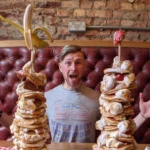 Café challenges brits diners to devour a towering stack of 12 fluffy pancakes at Polo Bar in just 15 minutes and win a free meal, plus a spot on their wall of fame!