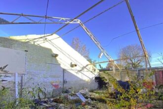 Inside the roofless garage available for sale at an auction 0.3 miles from Edgware Underground Station.