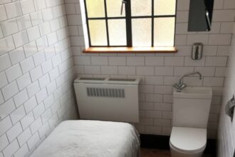 London's tiniest Airbnb stirs mixed reactions, likened to a prison cell but praised for cleanliness and location, offering budget-conscious travelers a compact stay now available for renting.