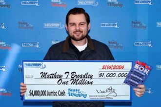 Man wins £800,000 on lottery from scratchcards in Valentine's Day card from his mother. He claimed his prize after discovering the win the night before.
