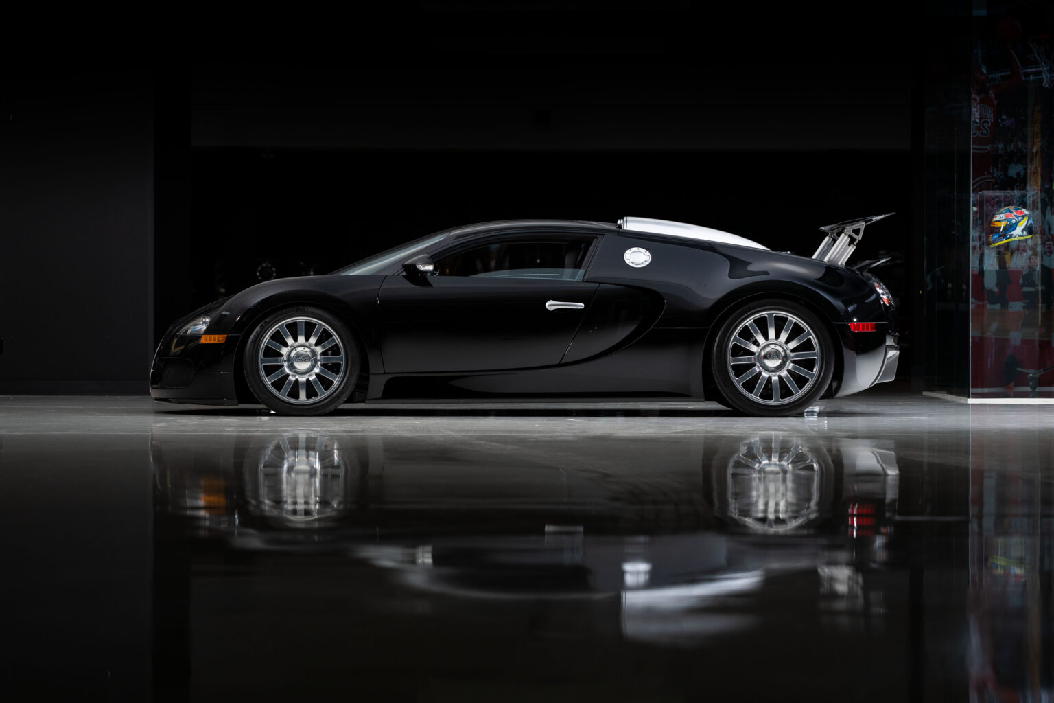 Simon Cowell's former Bugatti Veyron, bought for £1 million, now on sale for £1.3 million. Rare single-color black, top speed over 250mph.