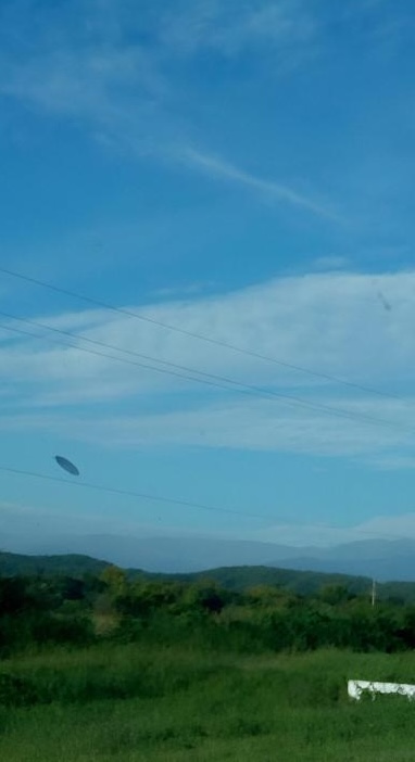 elderly couple on holiday in Argentina were amazed when they captured photos of a UFO while taking snapshots of the landscape.