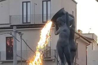 Sunlight filtering through near a public fountain creates a mesmerizing illusion of lava spewing from the Fontana Luminosa in L’Aquila, Italy.