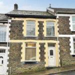 outside the modern two-bedroom house in Tonypandy, Wales available at an auction for a bargain.