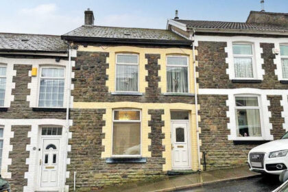 outside the modern two-bedroom house in Tonypandy, Wales available at an auction for a bargain.