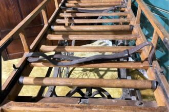 Victorian-era 'funeral cart' listed on Facebook Marketplace for £1,400. Once used for those unable to afford horse-drawn carriages, it's now a unique antique with fold-down wooden sides. Seller describes it as "one of the strangest things" they've sold.