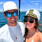 Emma and Andrew share their experience of living on a sailboat, highlighting both the challenges and savings compared to traditional housing. While adjustments like limited showers and power are necessary, they find fulfillment in the unique lifestyle and plan to continue sailing for the foreseeable future.