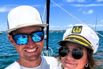 Emma and Andrew share their experience of living on a sailboat, highlighting both the challenges and savings compared to traditional housing. While adjustments like limited showers and power are necessary, they find fulfillment in the unique lifestyle and plan to continue sailing for the foreseeable future.