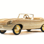 A half-sized 24-carat gold E-Type Jaguar covered in Swarovski crystals sells for £3,000, a fraction of its estimated value, but it's a pedal-powered kids' toy, not a full-size car.