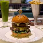 Critics slam Gordon Ramsay's £29.50 burger at Harrods for dry meat & hard cheese. Customers liken taste to "vomit".