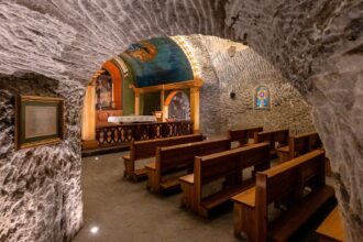 Discover the remarkable St Kinga's Chapel, nestled 101 meters underground in the Wieliczka Salt Mine near Krakow, Poland. This Easter, experience a special service in this awe-inspiring chamber, adorned with intricate salt sculptures and crystal chandeliers.