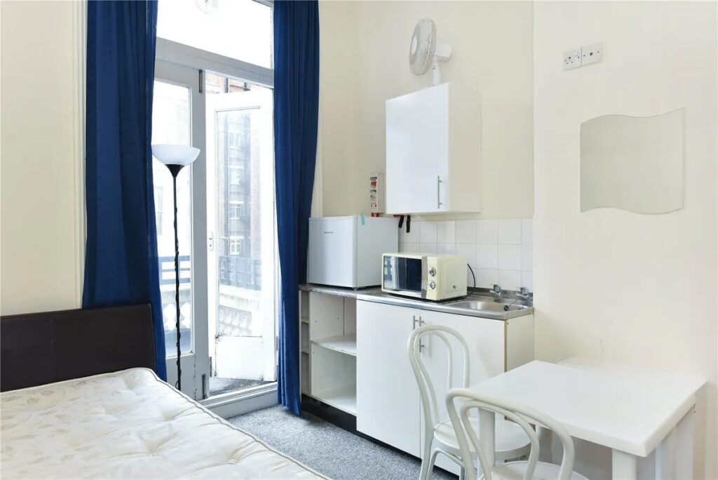 Experience London living in this £1,750 studio in desirable West Kensington, Zone 2. But beware, there's a catch - no toilet! Enjoy showering, cooking, and sleeping in one room, plus a balcony and bills included. Perfect for those seeking central location living.