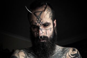 An ink enthusiast, Mattia, has spent over £25,000 on tattoos and body modifications, including eyeball tattoos and metal horns, despite facing criticism from family and friends. He embraces his unique appearance, stating that others' opinions are irrelevant. Despite challenges, he plans to continue modifying his body, emphasizing the importance of thorough research and personal desire in body modification.