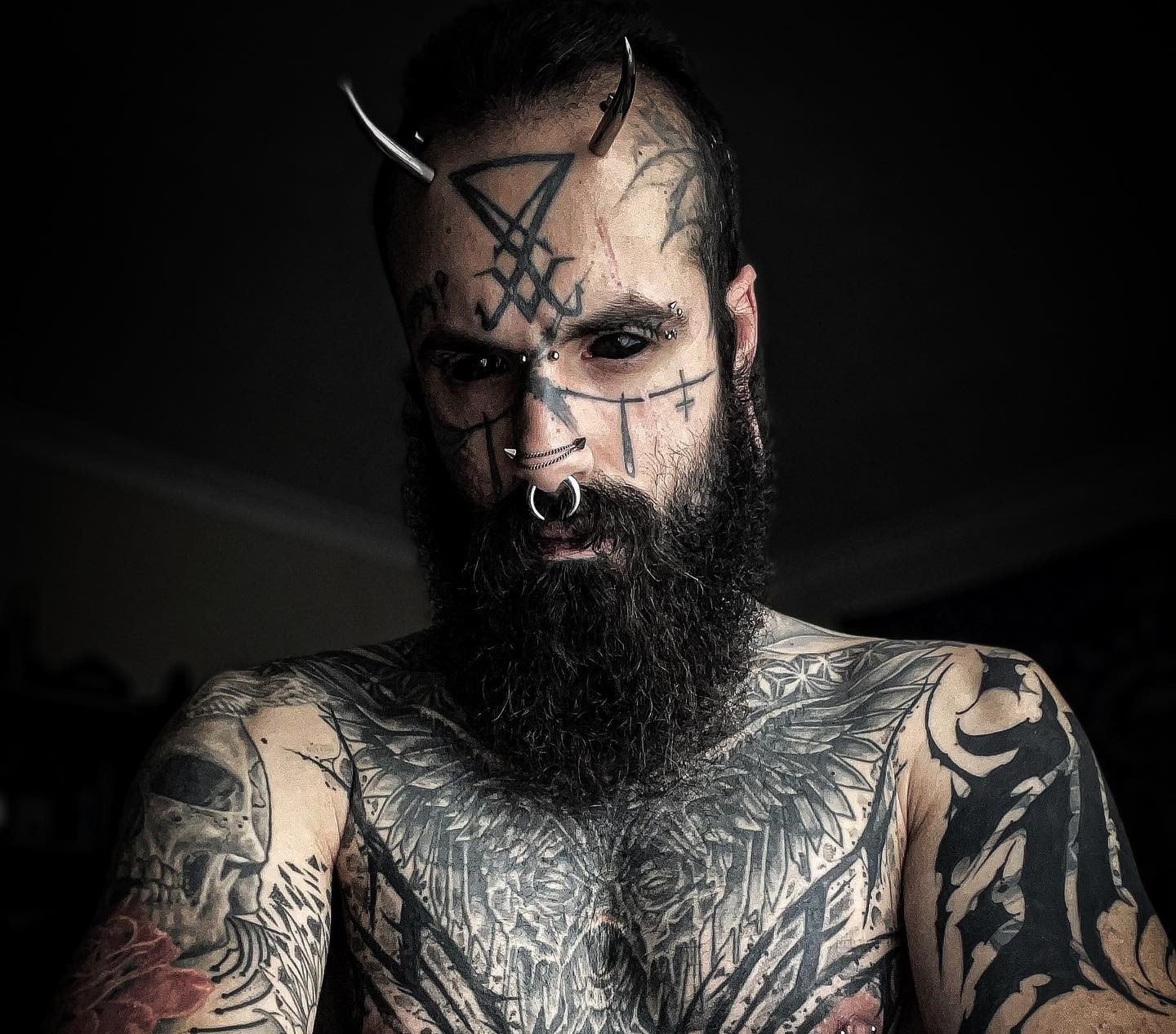 An ink enthusiast, Mattia, has spent over £25,000 on tattoos and body modifications, including eyeball tattoos and metal horns, despite facing criticism from family and friends. He embraces his unique appearance, stating that others' opinions are irrelevant. Despite challenges, he plans to continue modifying his body, emphasizing the importance of thorough research and personal desire in body modification.