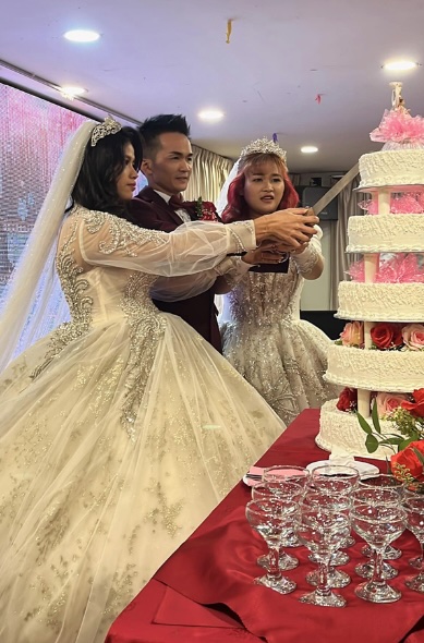A man's unconventional wedding to two brides sparks controversy in Kuching, Malaysia. Lim Soon Kian's celebration faces legal scrutiny, potentially facing charges for bigamy amid uncertainty over the marriage's official status.