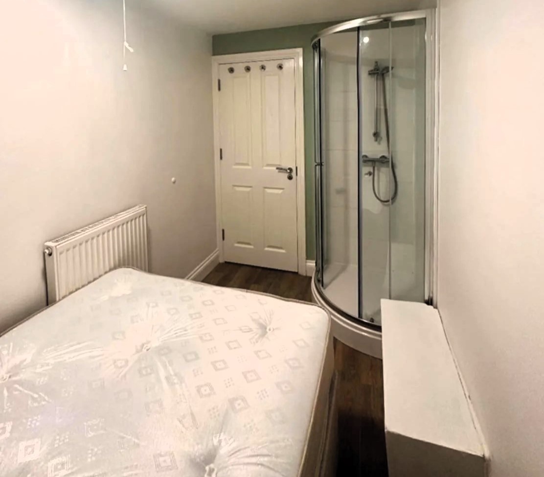 Basement Flat in Bristol Dubbed 'Prison Cell' with Shower Next to Bed Sparks Outrage Online. Hefty £1,550/Month Rent Stuns Viewers.