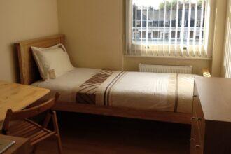 Tiny studio flat in central London with no oven or private bathroom costs £975/month. Furnished with only basic amenities, shared facilities, and no lounge area.