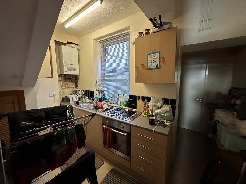 A Welsh terraced house with a surprising feature - a tiny bedroom likened to Harry Potter's cupboard under the stairs - goes viral online. Despite limited space, the property offers a large living room, kitchen, and more, but Reddit users question its two-bedroom classification.