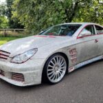 A crystal-covered 2005 Mercedes CLS500, perfect for weddings, is on sale for £7,000. With just 34,000 miles, it boasts bling both inside and out, complete with a red leather interior and built-in DVD player. Despite mixed reactions, it's a unique find!