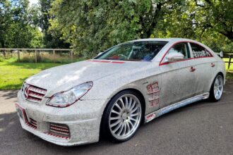 A crystal-covered 2005 Mercedes CLS500, perfect for weddings, is on sale for £7,000. With just 34,000 miles, it boasts bling both inside and out, complete with a red leather interior and built-in DVD player. Despite mixed reactions, it's a unique find!