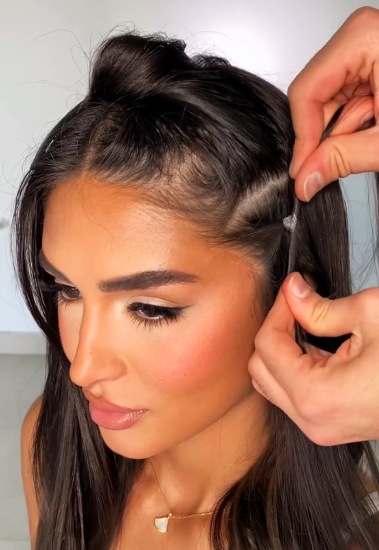Hairstylist Andi Asmaro shares a viral hair hack on Instagram, demonstrating a technique to create a facelift illusion at home. While praised for its transformative effect, some viewers express concern over potential discomfort. Despite this, the technique gains popularity, with many applauding its ingenuity and effectiveness.