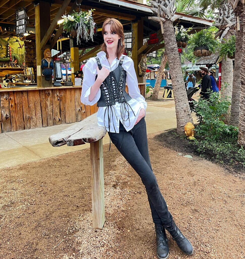 Maci Currin, with record-breaking legs, embraces uniqueness despite trolls' comparisons to Slenderman. Standing at 6'10", she's empowering tall women worldwide.