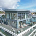 A luxurious duplex penthouse in Falmouth, Cornwall, boasting stunning views and modern features, is on sale for £1.8m, having hosted celebrity guests like Robbie Williams.