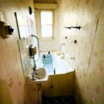 A fixer-upper cottage in Nuneaton is generating buzz with its eerie interior and a cramped bathroom featuring an oddly placed tub. Despite the need for renovation, its prime location and potential for expansion make it an attractive prospect for buyers. Listed at £90,000, it's set to go to auction with Pointons Estate Agents.