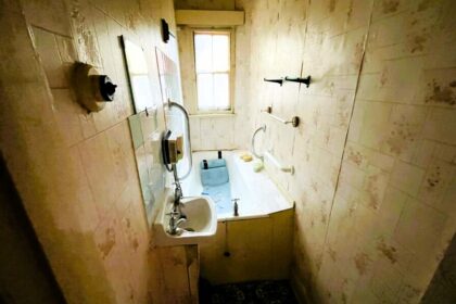 A fixer-upper cottage in Nuneaton is generating buzz with its eerie interior and a cramped bathroom featuring an oddly placed tub. Despite the need for renovation, its prime location and potential for expansion make it an attractive prospect for buyers. Listed at £90,000, it's set to go to auction with Pointons Estate Agents.