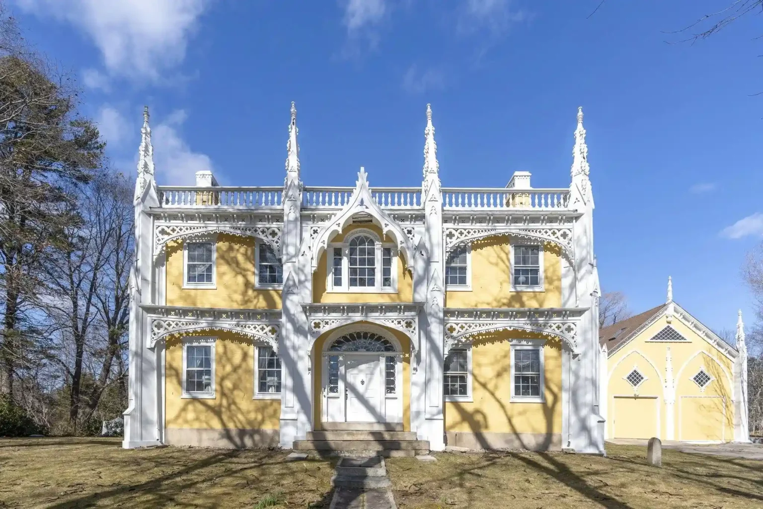 The iconic 'wedding cake' house in Kennebunk, Maine, known for its intricate gothic trim, hits the market for £2 million. With stunning river views and historical charm, it offers over 6,000 square feet of living space, including five bedrooms, vintage interiors, and potential for renovation.