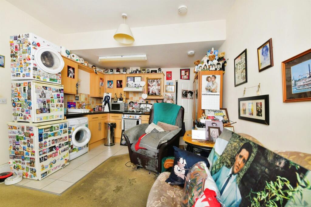 A one-bed house in Plymouth hits the market for £80,000, but it's filled with Elvis Presley memorabilia, prompting online reactions ranging from amusement to skepticism.