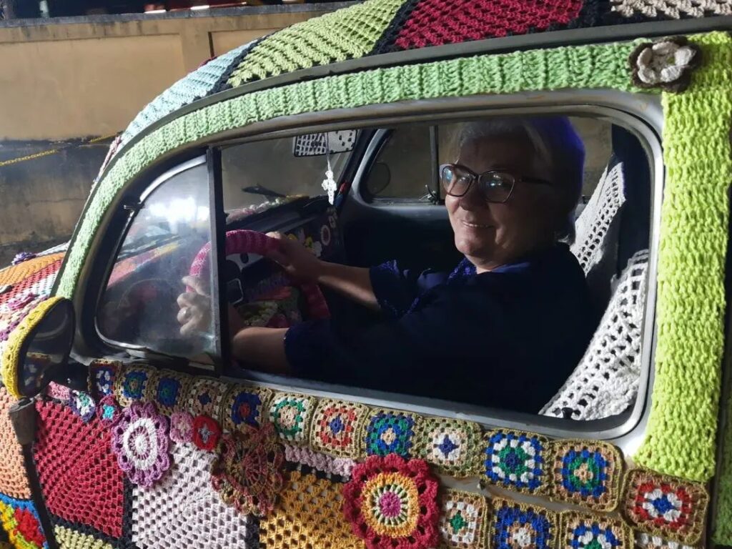 Ana Lúcia Vergetti, a color-loving grandmother from Brazil, spent six months adorning her entire VW Beetle with eye-catching crochet as a unique advertisement for her haberdashery business. Her intricate design, including flowers and an owl, has captured the attention of locals and passersby alike.