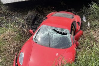A mechanic crashes a £450,000 Ferrari into a ditch while testing it after repairs in Bangkok. The supercar, a Ferrari F430, sustains significant damage, while the mechanic escapes with minor injuries. Investigation underway.