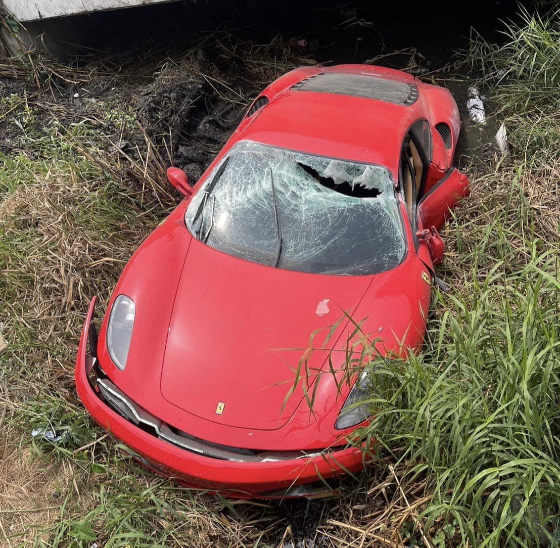 A mechanic crashes a £450,000 Ferrari into a ditch while testing it after repairs in Bangkok. The supercar, a Ferrari F430, sustains significant damage, while the mechanic escapes with minor injuries. Investigation underway.